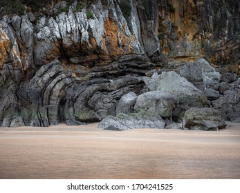 Complex rock formations on a sandy beach