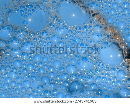 complex shadow pattern of air bubbles on the surface of toxic liquid