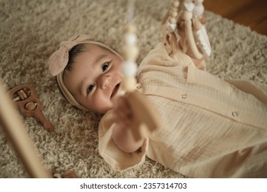Complexity of Simplicity: A photograph that unpacks the complexity of a baby s life as she lays on a neutral rug, finding joy and relief in the most uncomplicated of activities