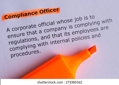 compliance officer word highlighted on the white paper