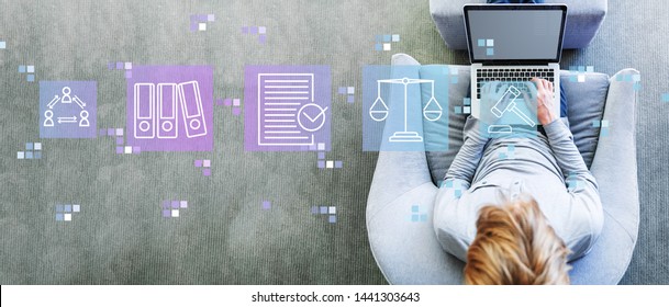 Compliance theme with man using a laptop in a modern gray chair - Shutterstock ID 1441303643