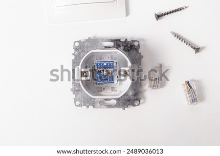 Components of Internet outlet. Inside of the socket with contacts, screws and internet cable terminals on white background