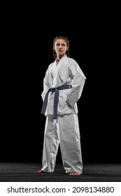 Composed. One Young Girl, Teen, Taekwondo Athlete Posing Isolated Over Dark Background. Concept Of Sport, Education, Skills, Workout, Healthy Lifestyle And Ad. Power And Energy.