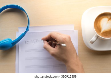 Composing Music Note  Top View With Hand Writing Coffee And Blue