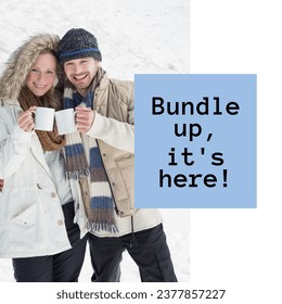 Composite of bundle up it's here text over caucasian couple with mugs in winter scenery. Winter, christmas, seasons and celebration concept digitally generated image.