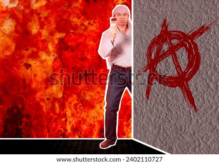 Composite collage. A man paints an anarchy sign on the wall of a building. There is a burning fire behind. Chaos and unrest period concept