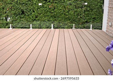 Composite deck with glass panel railing as a durable solution.