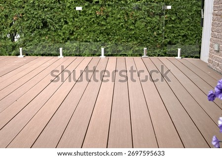 Composite deck with glass panel railing as a durable solution.