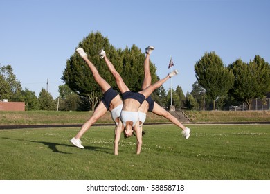 A composite of a female athlete performing a cartwheel on a grassy field. - Powered by Shutterstock