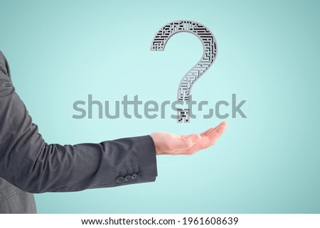 composite of hand holding questionmark graphic with blue background
