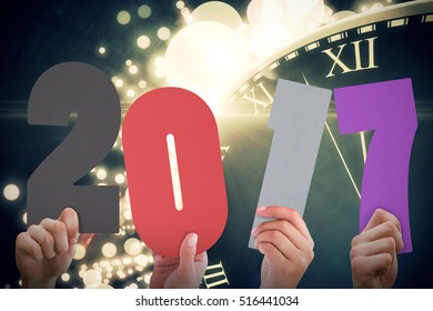 Composite image of 2017 message held up by hands