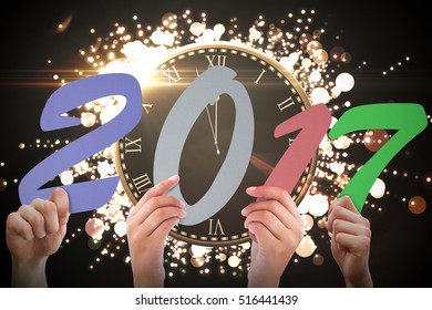 Composite image of 2017 message held up by hands
