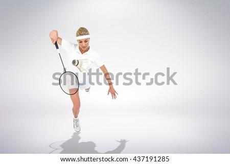 Composite image of badminton player playing badminton against white background