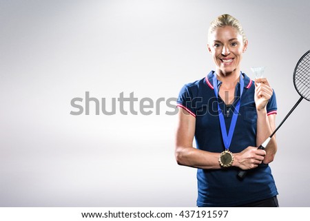 Composite image of badminton player posing with gold medal around his neck against white background