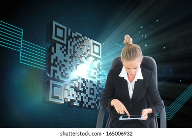 Composite image of blonde businesswoman sitting on swivel chair with tablet