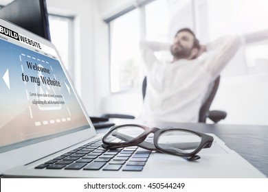 Composite Image Of Build Website Interface Against A Businessman Relaxing In His Chair