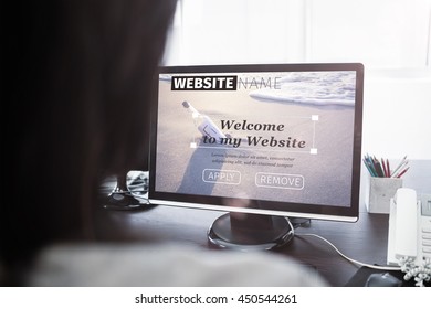 Composite image of build website interface against casual businesswoman working on laptop Casual businesswoman working on laptop at office