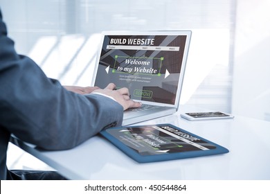 Composite Image Of Build Website Interface Against Businessman Using His Computer