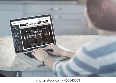 Composite image of build website interface against woman using a laptop in the kitchen