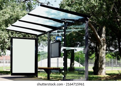 Composite Image Of Bus Shelter At Bus Stop Of Blank Light Box And Glass Structure. Park-like Urban Setting. Green Background. Safety Glass Design. White Poster Ad Commercial Poster Space Display Glass