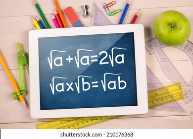 Composite Image Of Digital Tablet On Students Desk Showing Math Equations