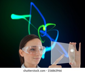 Composite image of doctor in protective glasses holding virtual screen on black background with glowing blue and green lines - Powered by Shutterstock