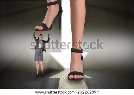 Composite image of female feet in black sandals standing on businesswoman against grey room with arrow door