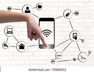 Composite image of hand using a smartphone with application icons