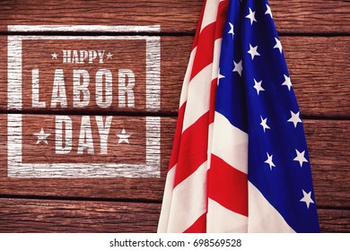 Composite image of happy labor day poster against american flag on a wooden table - Shutterstock ID 698569528