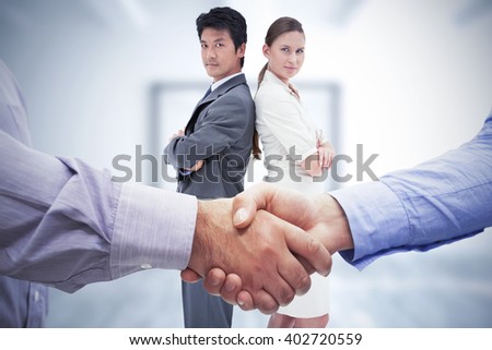 Composite image of men shaking hands