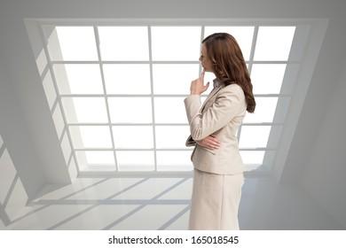 Composite image of profile view of doubtful businesswoman standing