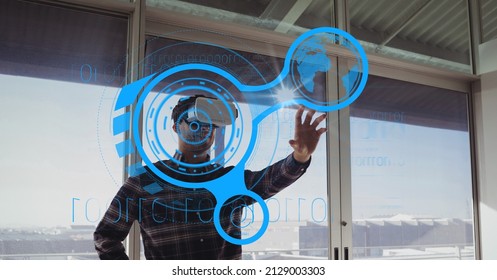 Composite image of round scanner and data processing against african american man wearing vr headset. business and futuristic technology concept