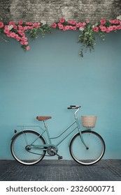 Composite image of a scene featuring a classic bicycle leaning against a wall adorned with beautiful flowers. The wall offers a blank space, perfect for adding your own custom text or message