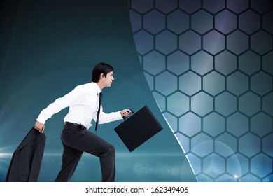 Composite image of side view of walking tradesman with jacket and suitcase 