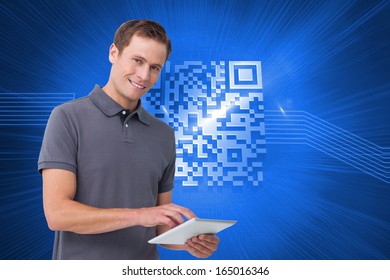 Composite image of smiling young man with tablet computer