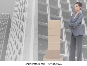 Composite image of stack of carboard boxes and caucasian businesswoman against tall buildings. business concept