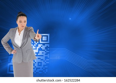 Composite image of unsmiling asian businesswoman pointing