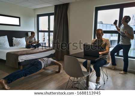 Composite of multiple clones doing different activities at home during lockdown due to COVID pandemic in France