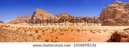 Composite panorama of high resolution aerial photos of a monolithic mountain in the central area of the desert reserve of Wadi Rum, Jordan, middle east