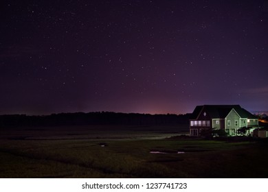 A composite of the starry night over a marsh