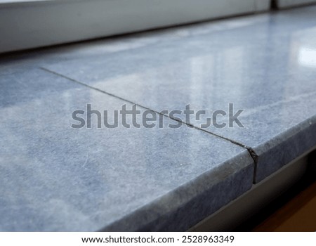 Composite window sill made from two pieces of marble slab. 