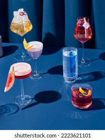 Composition with alcohol cocktails on coloured background with harsh shadows. Trendy concept cocktail menu. Set of cocktails on blue background. Bartender cocktails in minimal modern style - Shutterstock ID 2223621101