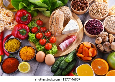 Composition with assorted organic food products on wooden kitchen table. - Shutterstock ID 1377446807
