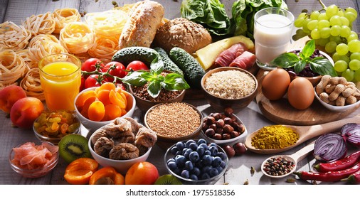 Composition with assorted organic food products on wooden kitchen table.
