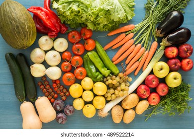 Composition with assorted raw organic vegetables on a blue wooden background - Shutterstock ID 489522214