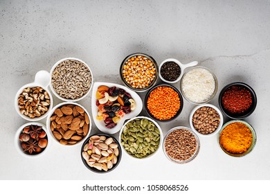 Composition with assortment of superfood products in bowls on gray background, top view - Shutterstock ID 1058068526