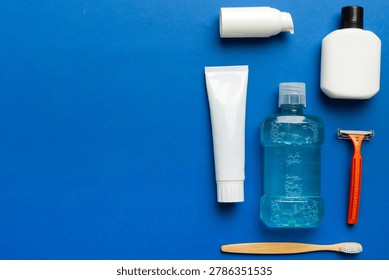 Composition with bath cosmetics on table. razor, toothpaste, soap, gel, toothbrush, mouthwash and other various accessories. Cosmetics for skin health. Bath Mockup for your logo.
