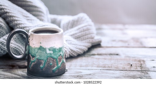 composition with a beautiful handmade cup on a wooden background