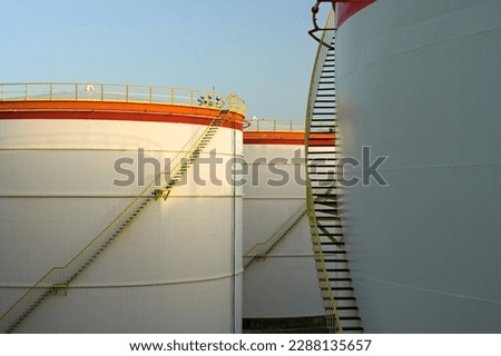 Composition with big oil tanks, stairs and shadows of the morning light.