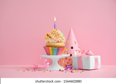 Composition with birthday cupcake on pink background